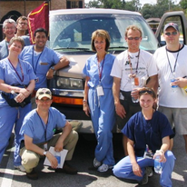 group of health care workers near van